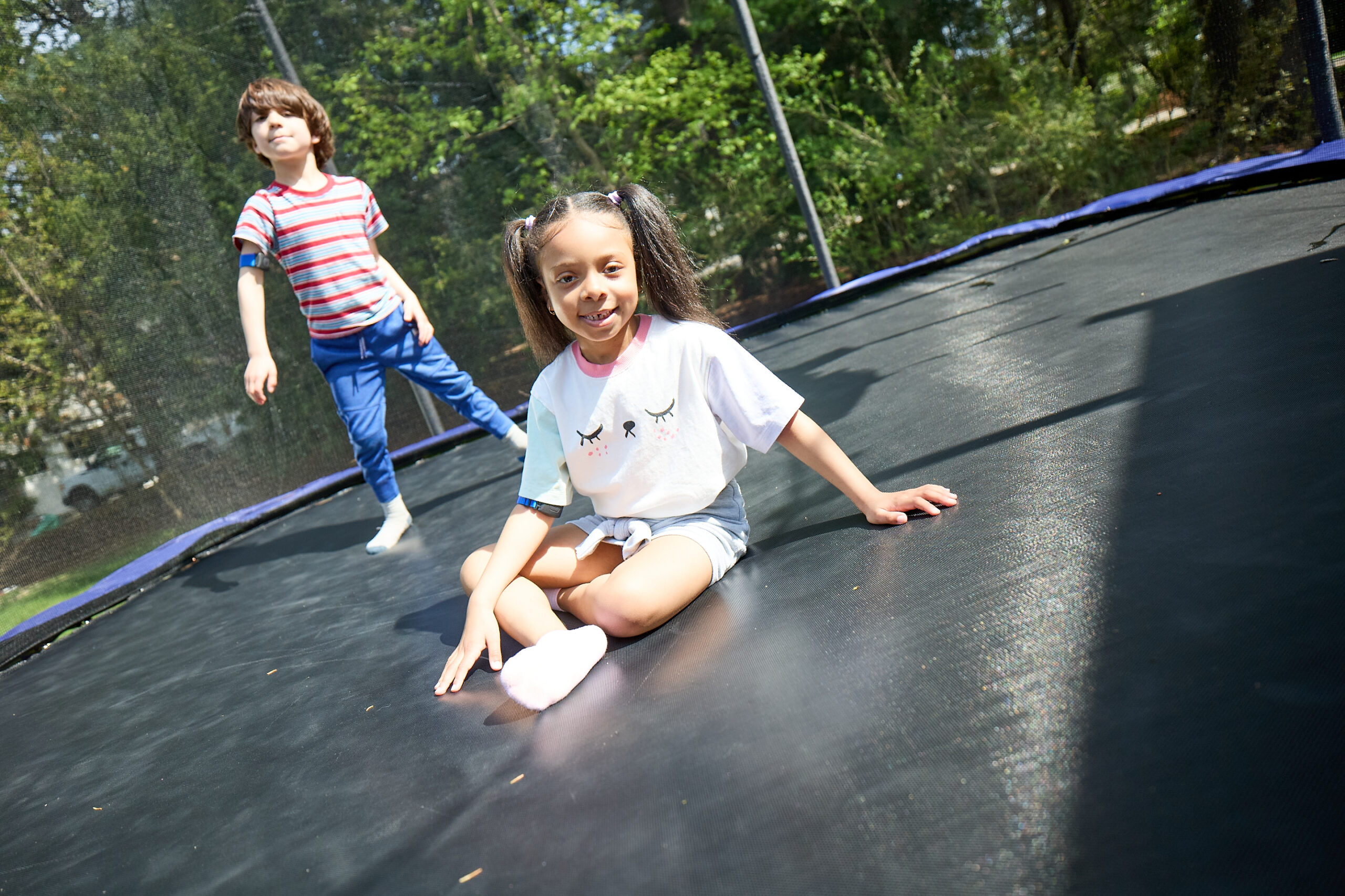 two kids jumping on trampoline